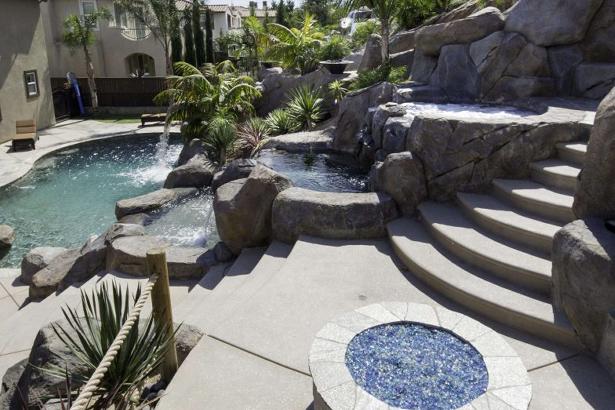 A semi aerial shot of a luxury pool in a backyard