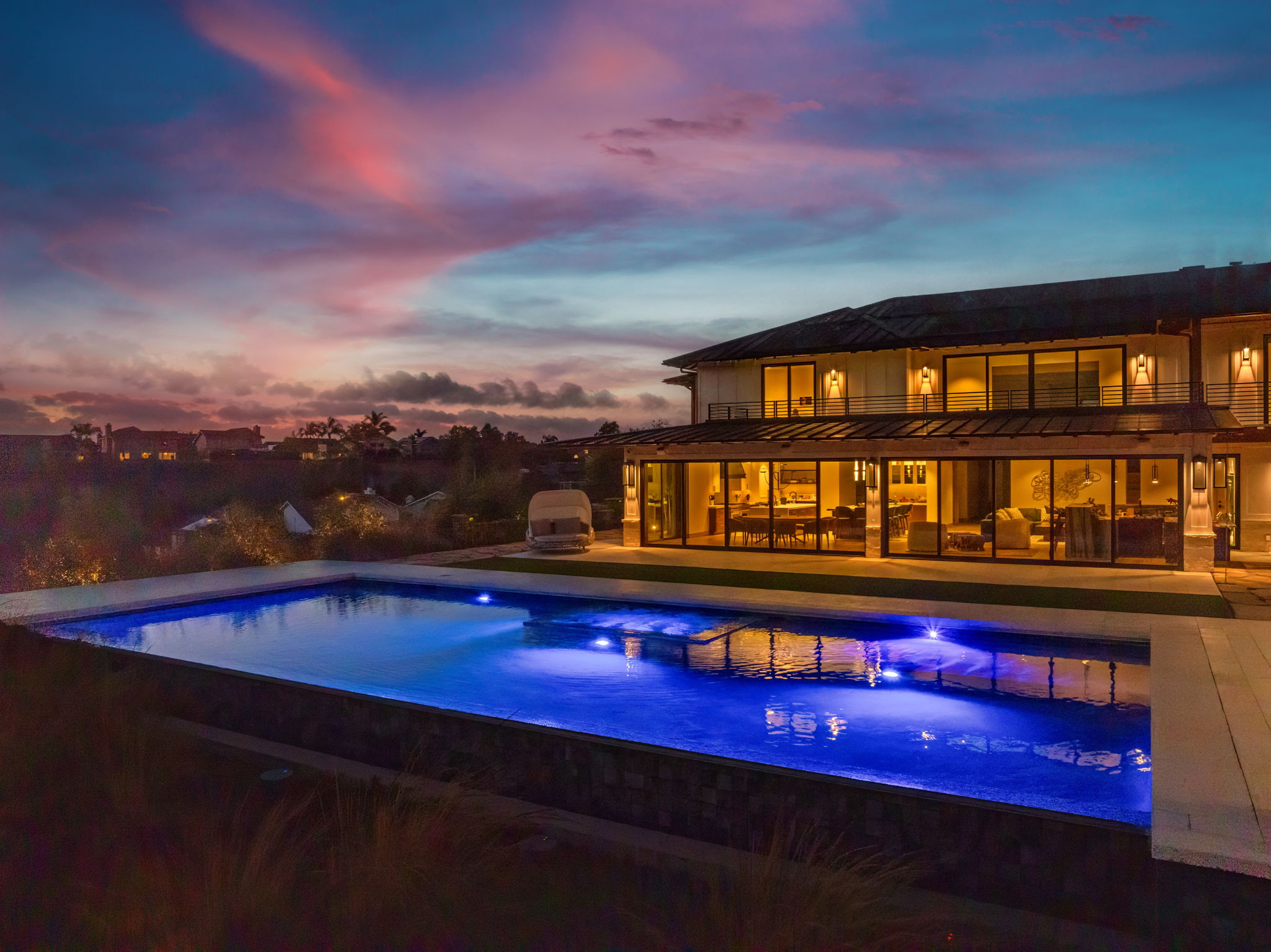 Infinity-edge pool with blue LED lighting at night