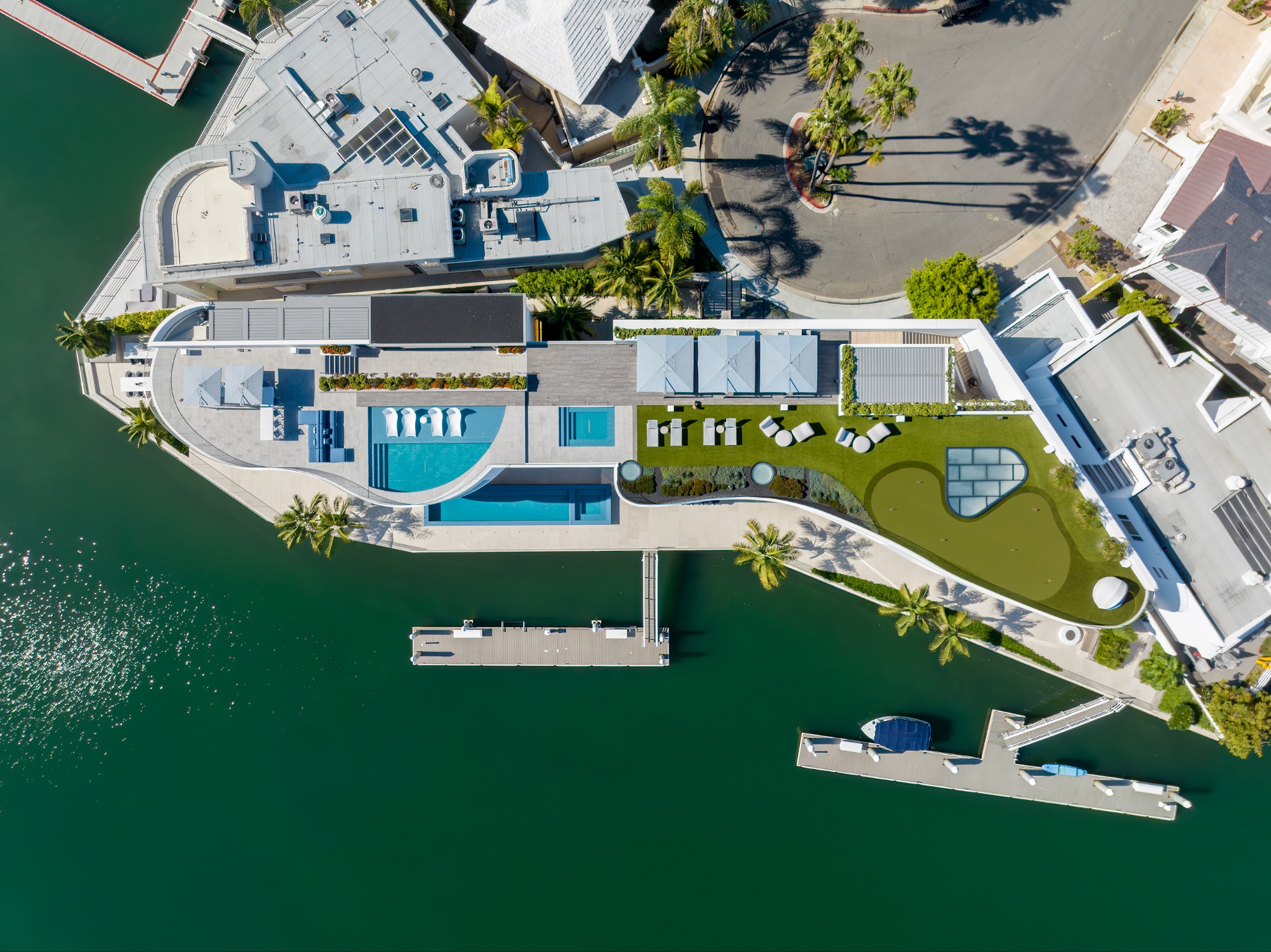 Aerial view of waterfront commercial property with renovated pool