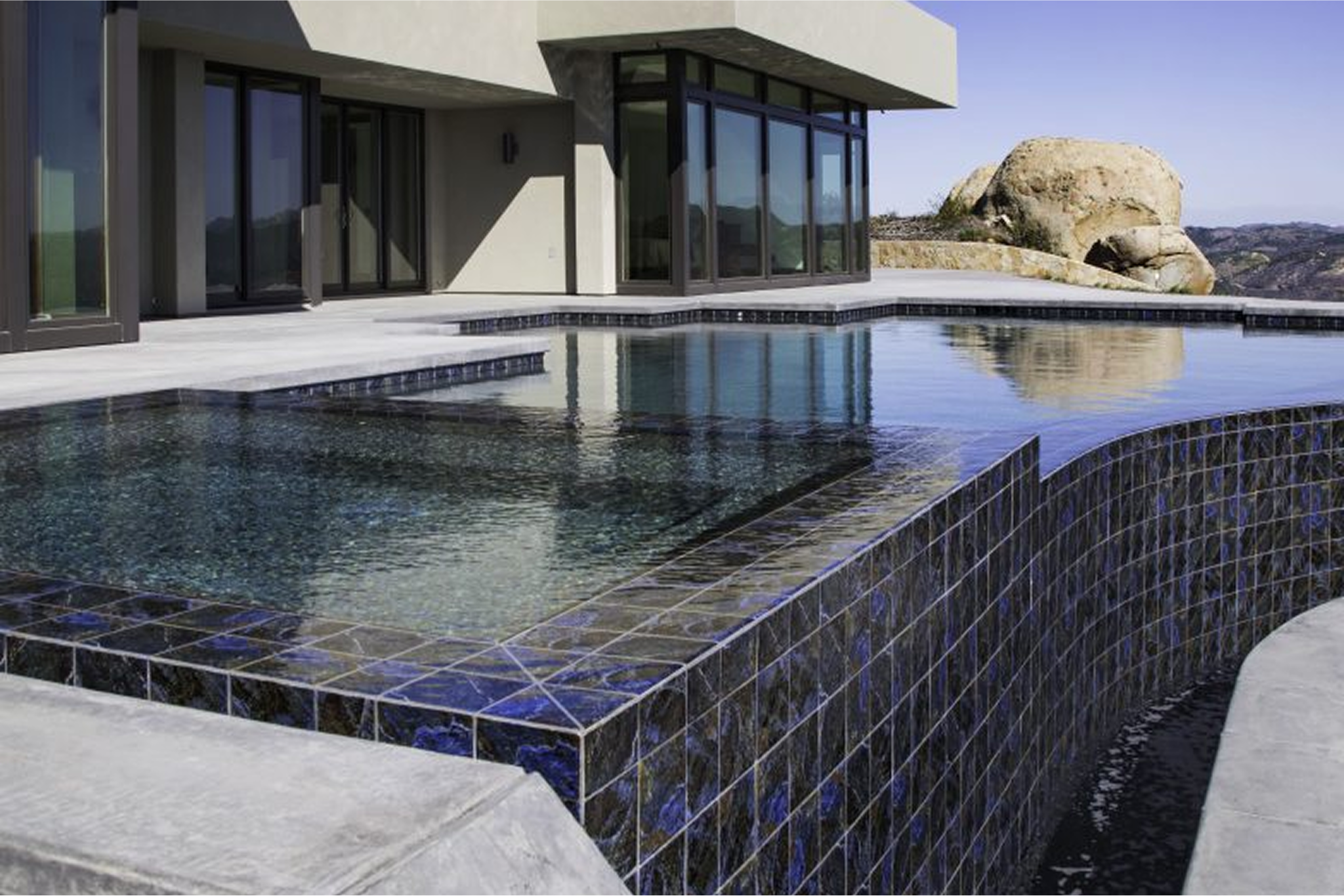 A view of a luxury swimmimg pool with brickwork
