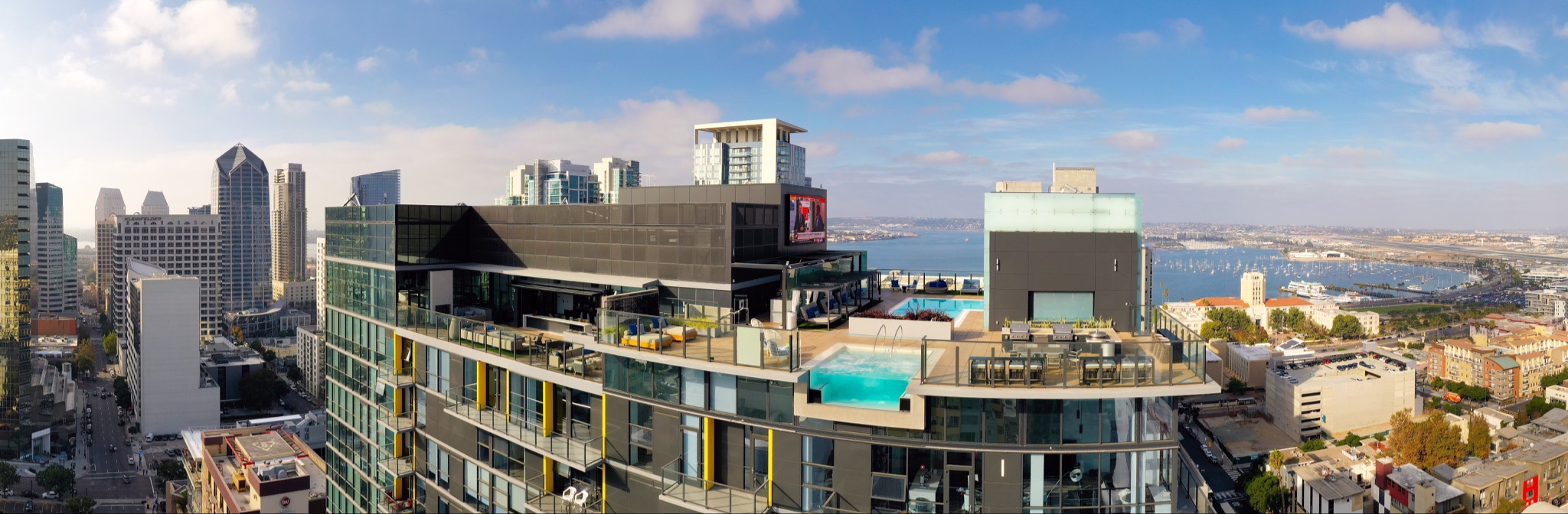 Aerial panorama of rooftop pool overlooking San Diego skyline