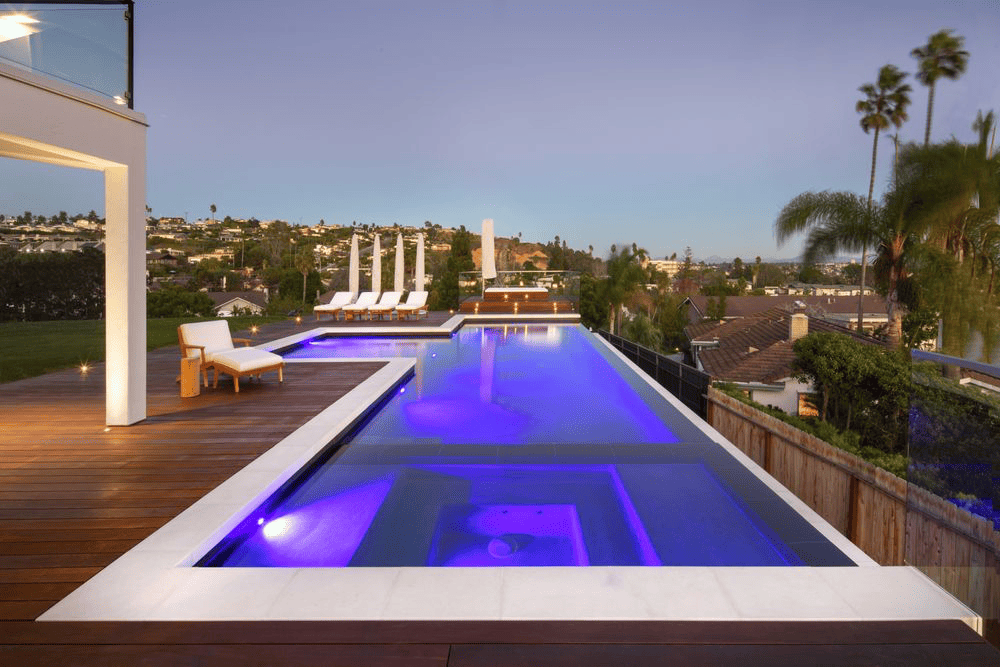 Modern pool with LED lighting and city view