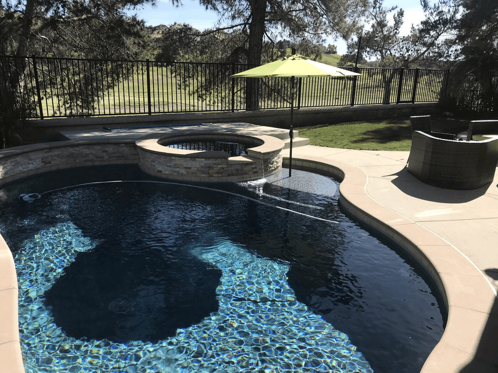 Infinity edge concrete pool with sunset overlook.