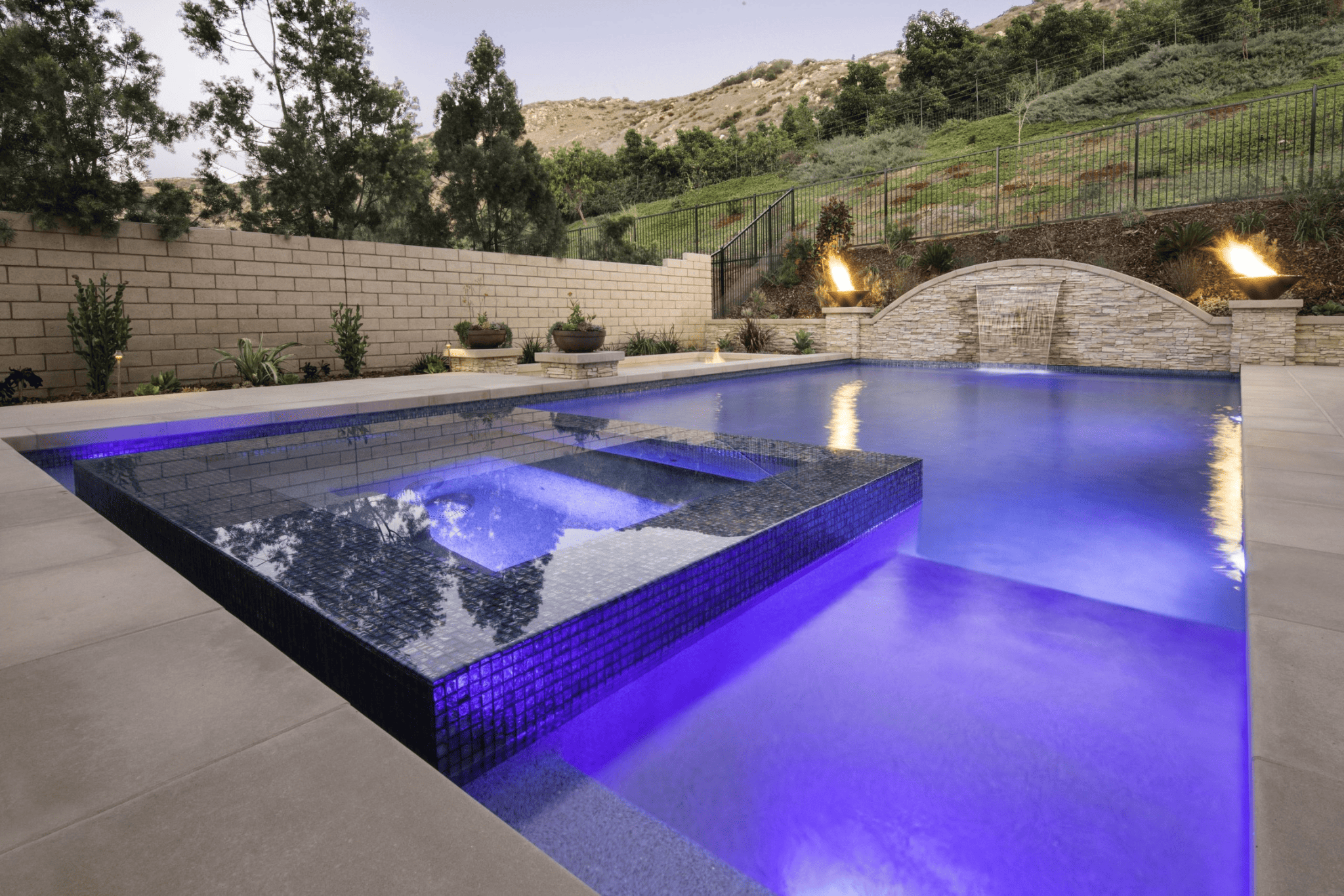 A luxury pool in the afternoon with purple ambient lighting
