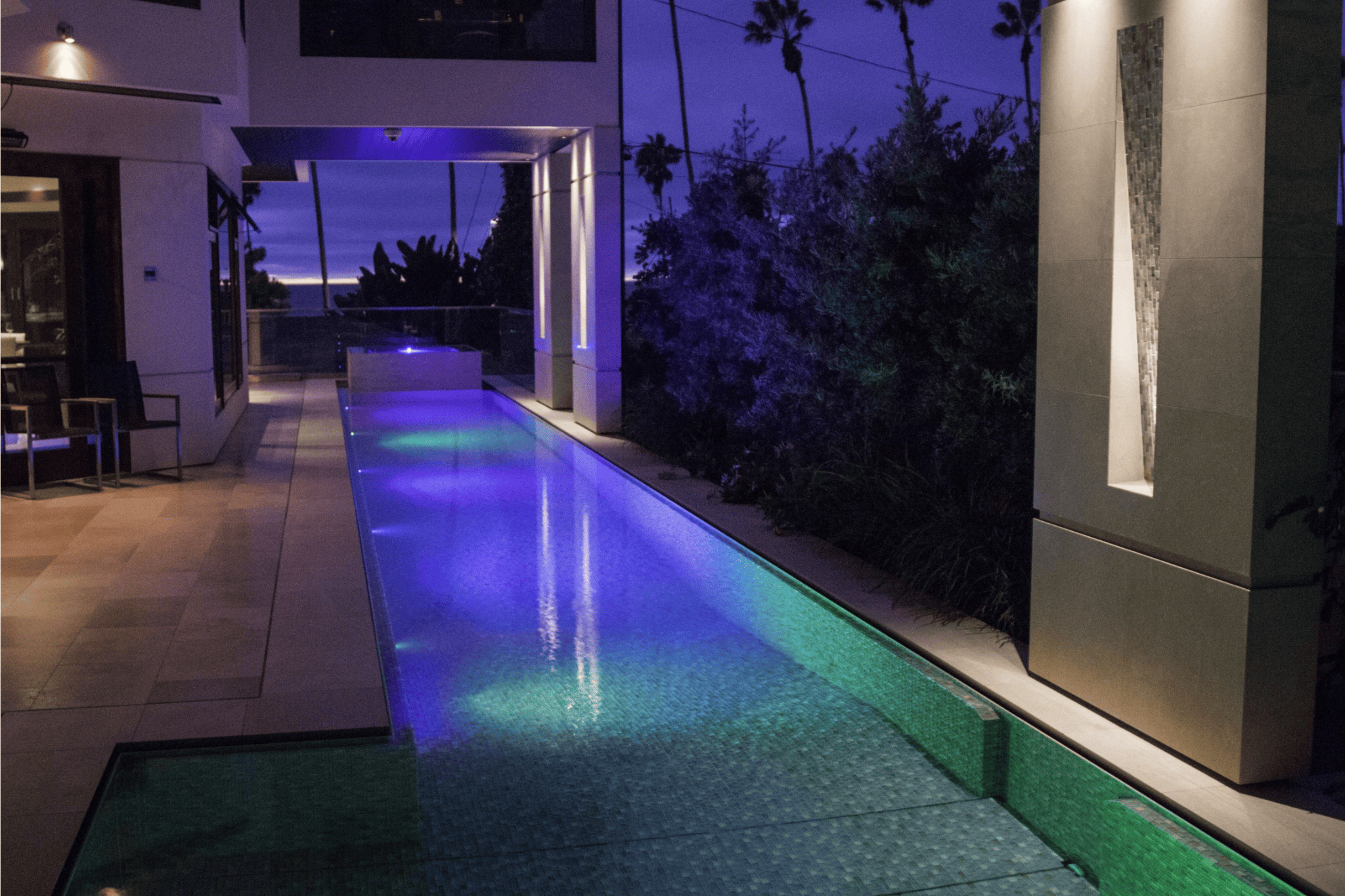 A luxury pool with ambient lighting in the evening