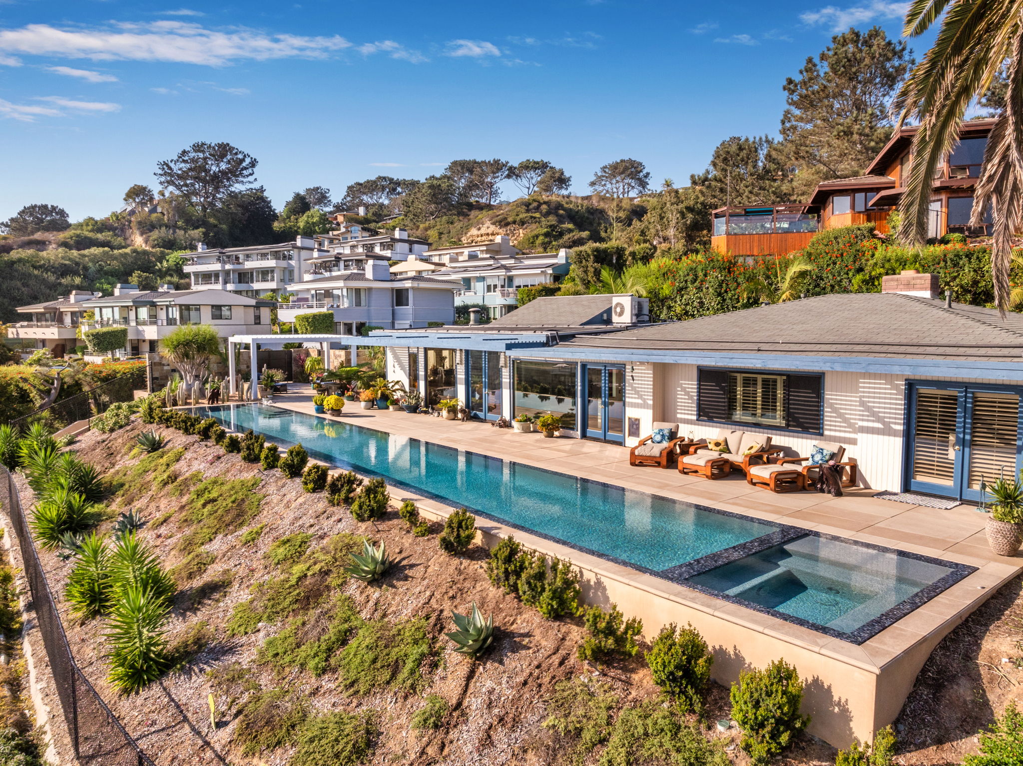 Hillside infinity pool with integrated spa on coastal property