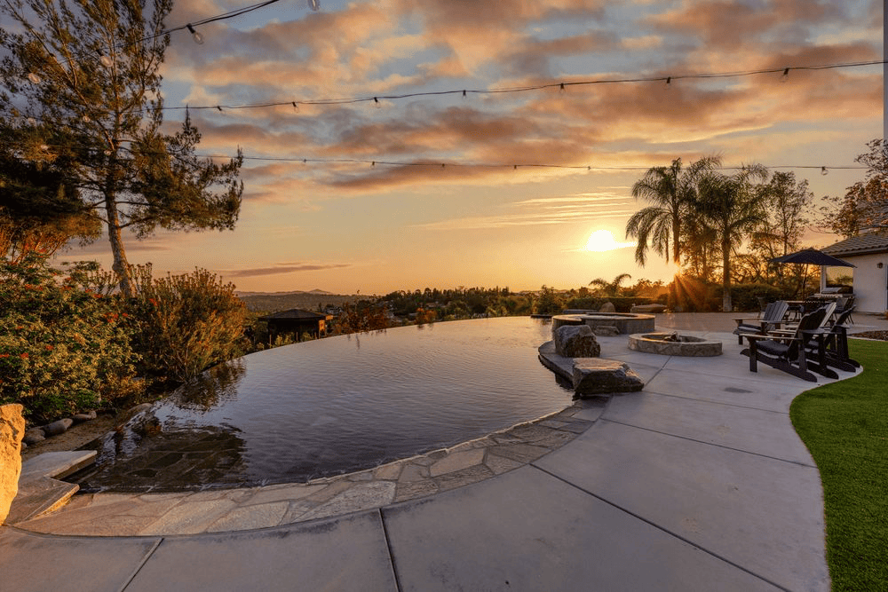 Compact pool with rock waterfall water feature.