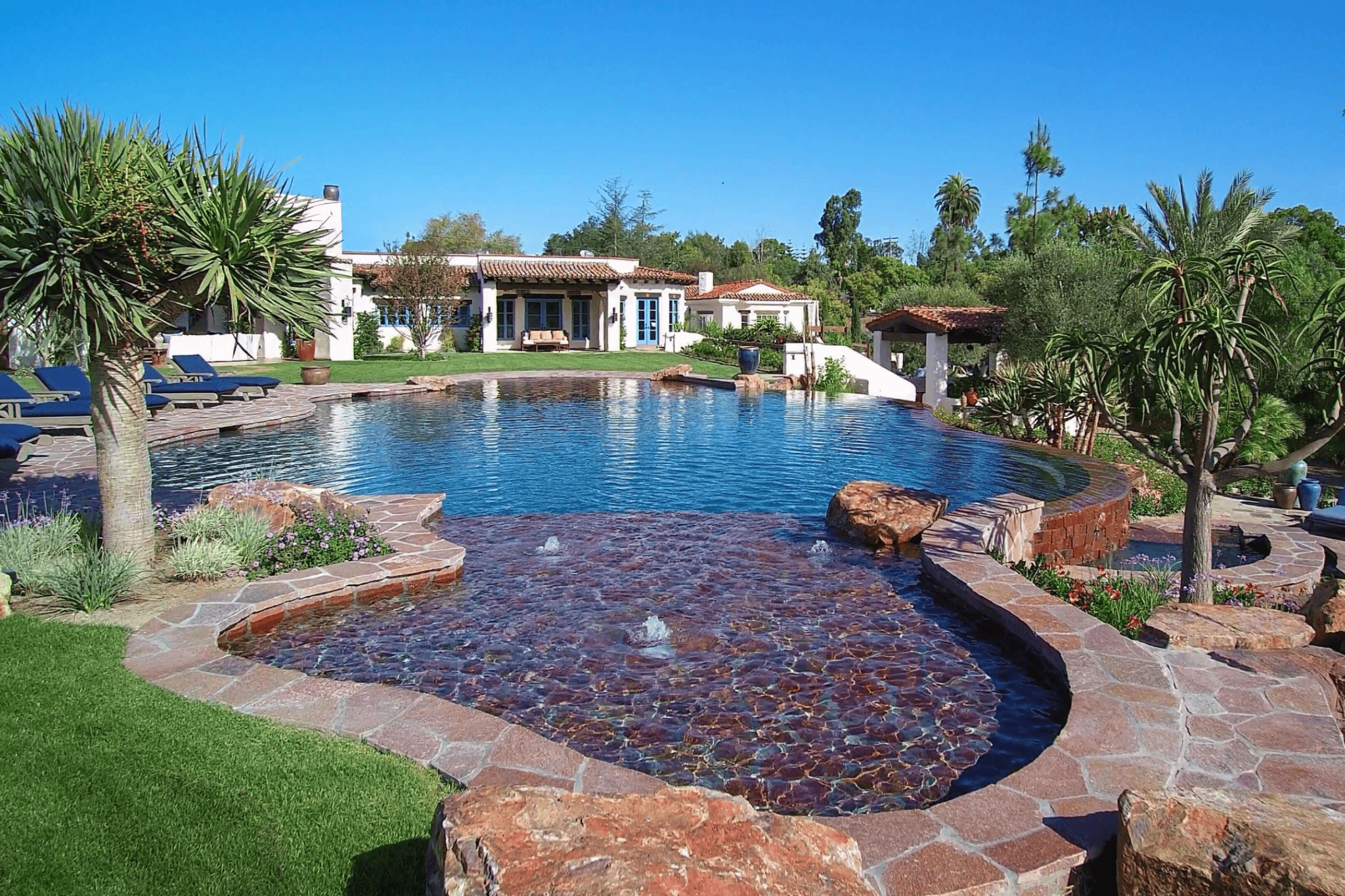 A luxury pool with rocks at the base