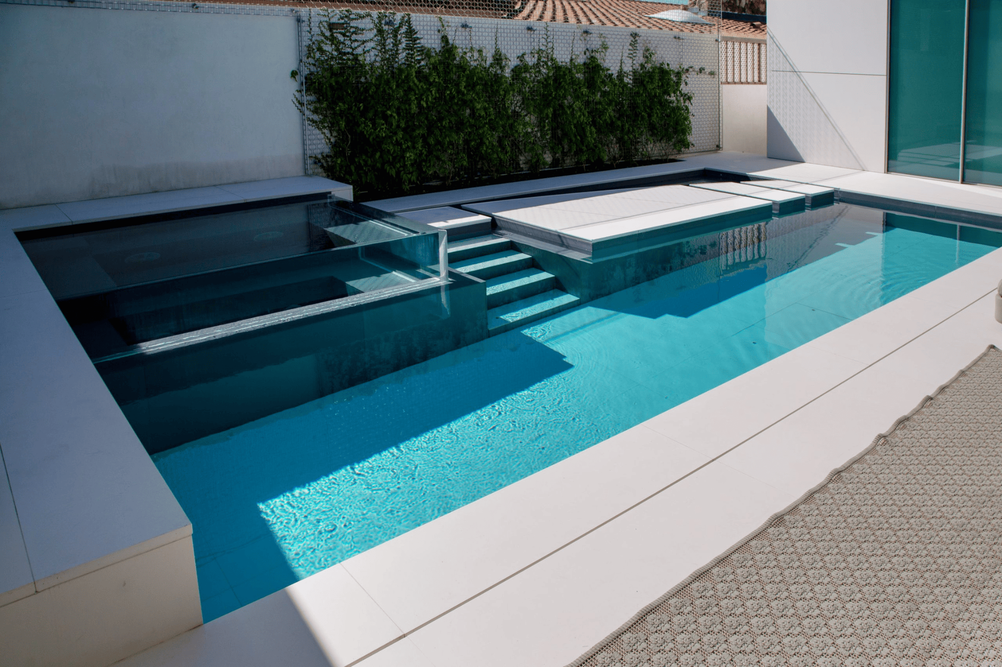 A luxury pool in the daytime with a glass feature