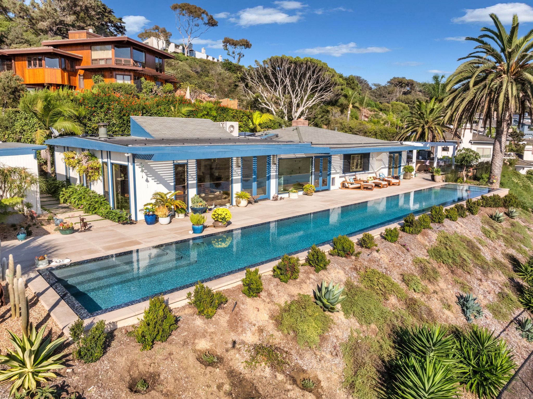 Aerial view of hillside infinity pool on a Southern California coastal property