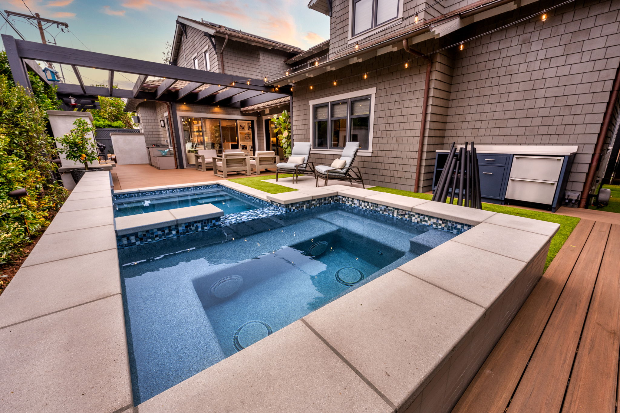 Modern geometric inground pool with patio and pergola