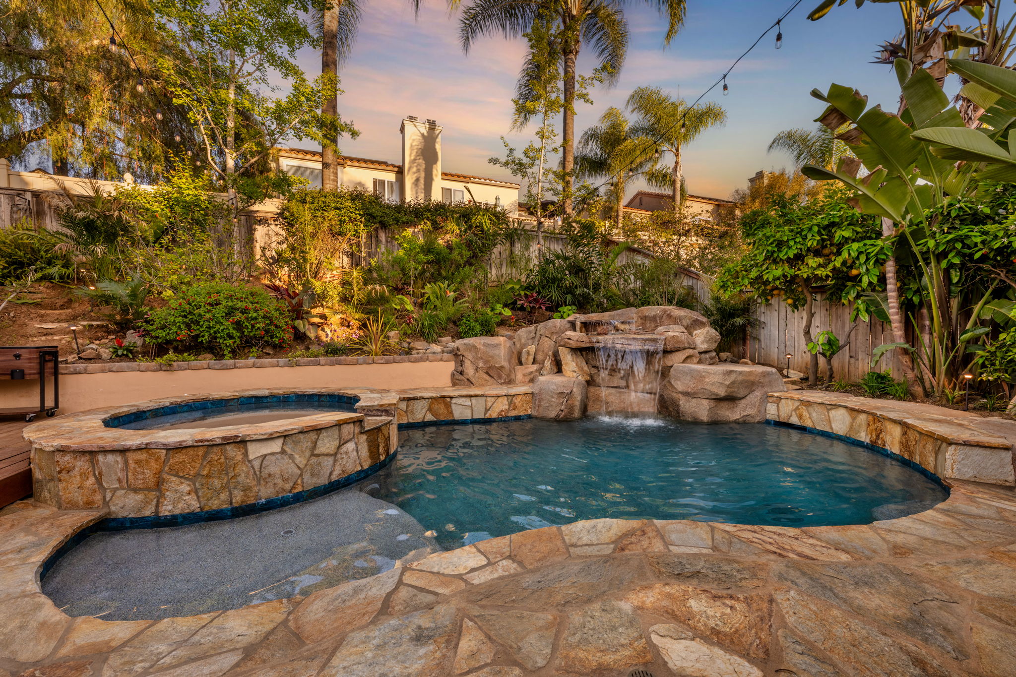 Natural stone pool with rock waterfall and spa
