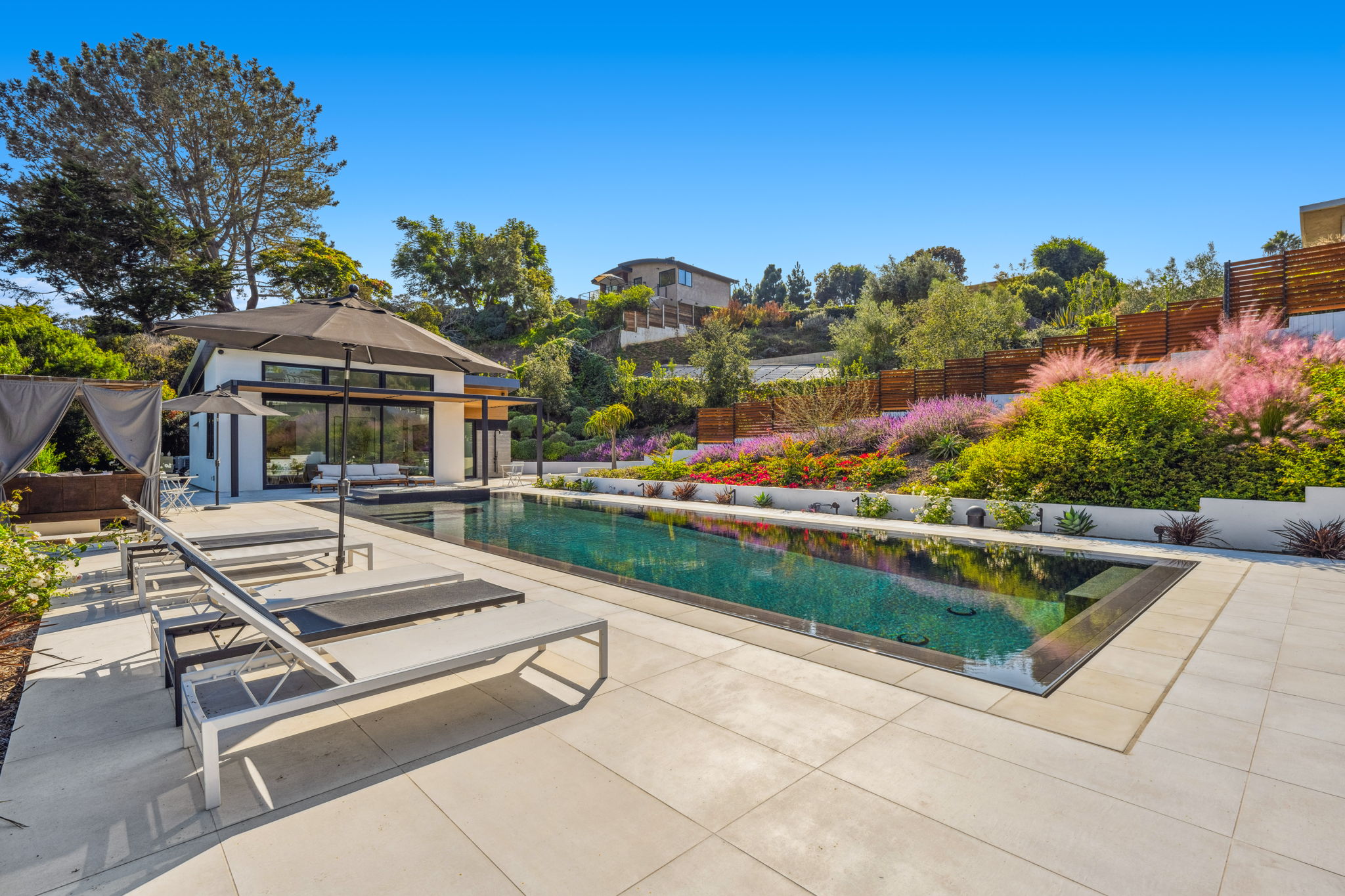 Modern gunite pool with a perimeter overflow edge, designed and built by Mission Pools in Southern California
