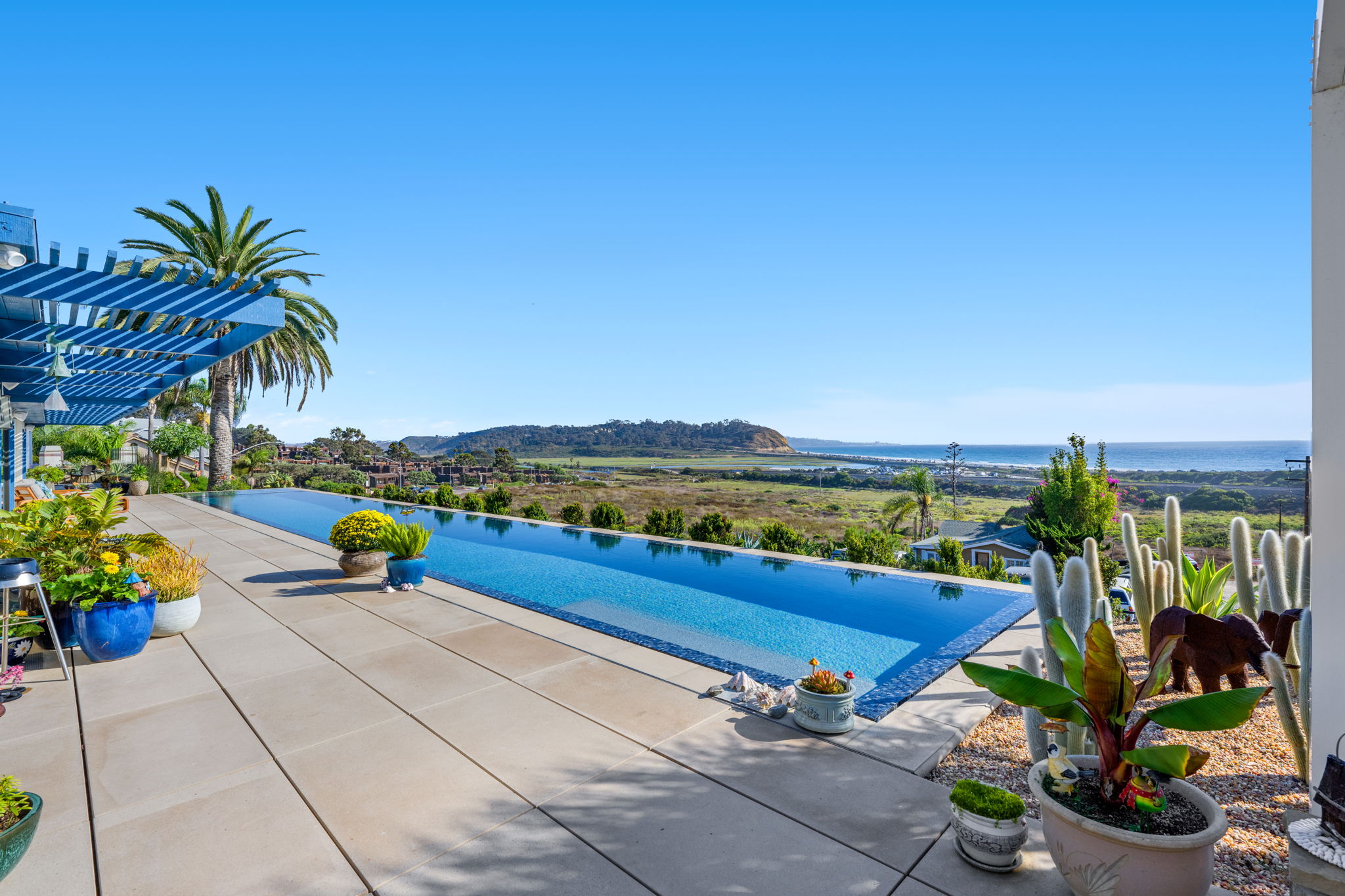 Infinity pool installation with ocean and valley views, a custom backyard pool build by Mission Pools