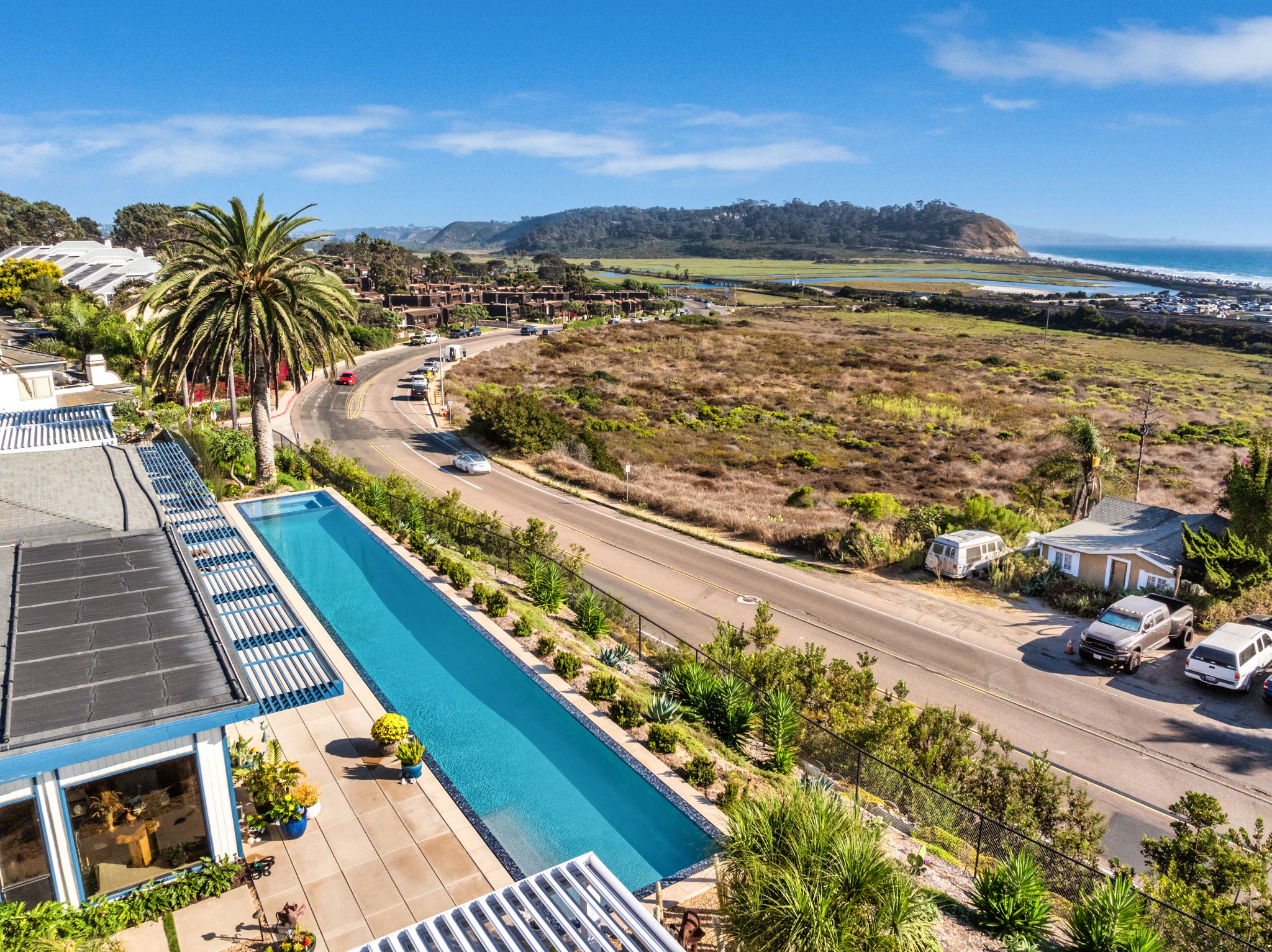 Custom lap pool installation on a coastal California lot, showing how site conditions shape the backyard pool installation timeline